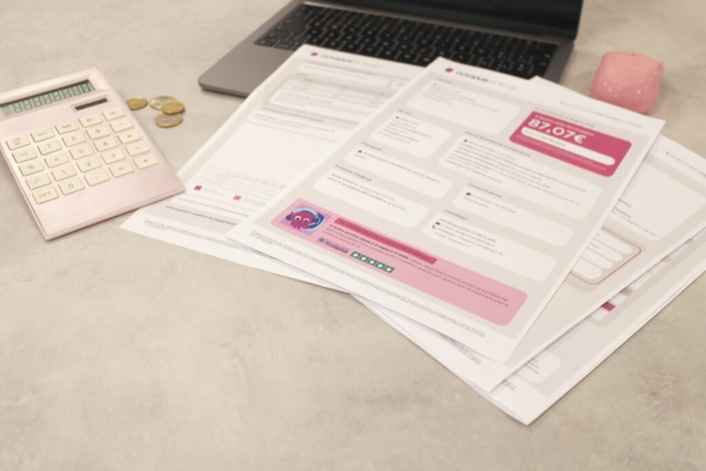 Invoices and a calculator on a desk, part of payment processing fees explained step by step