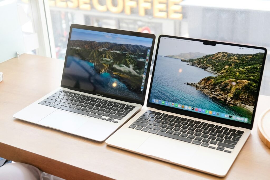 Two laptops side by side representing a QuickBooks alternatives comparison
