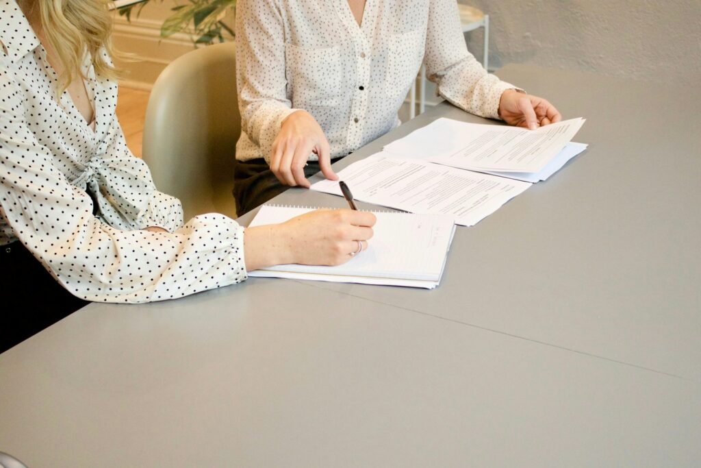 Two people reviewing financial documents together during a bookkeeping consultation