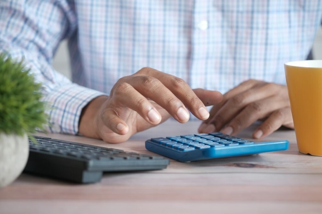 Calculating small business software costs at a desk