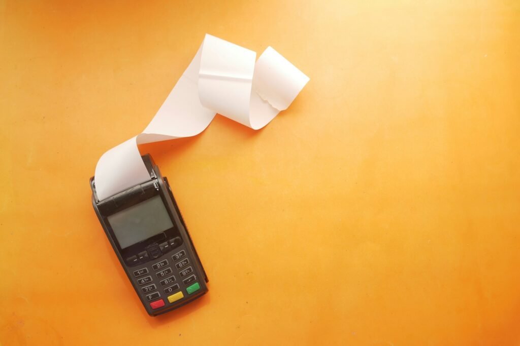Payment terminal printing a receipt, part of Square fees explained by transaction type