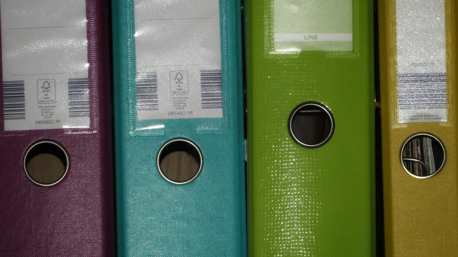 Row of colored folders on a shelf, representing how to set up a chart of accounts in QuickBooks