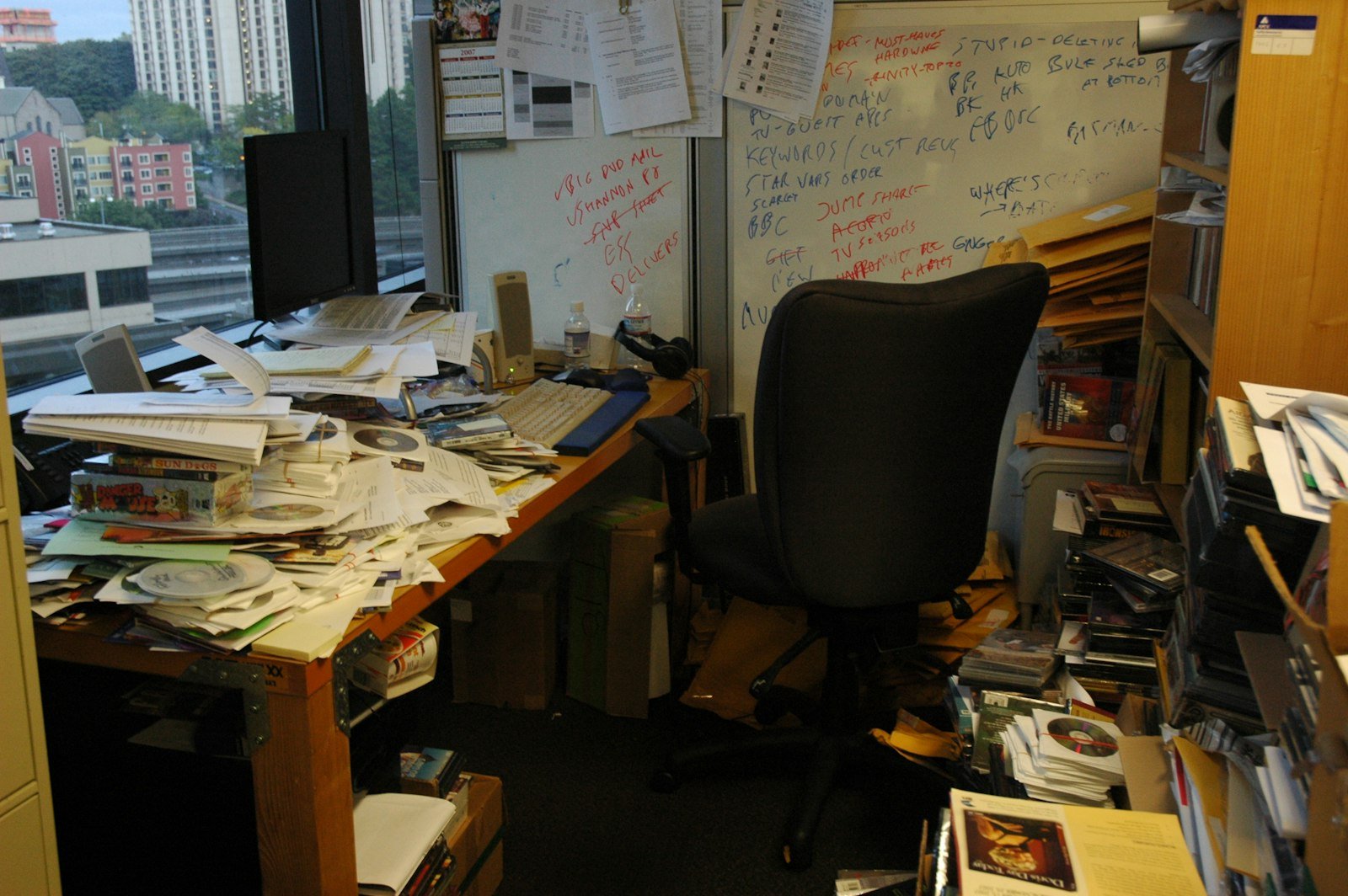 Office desk covered with stacks of paper documents