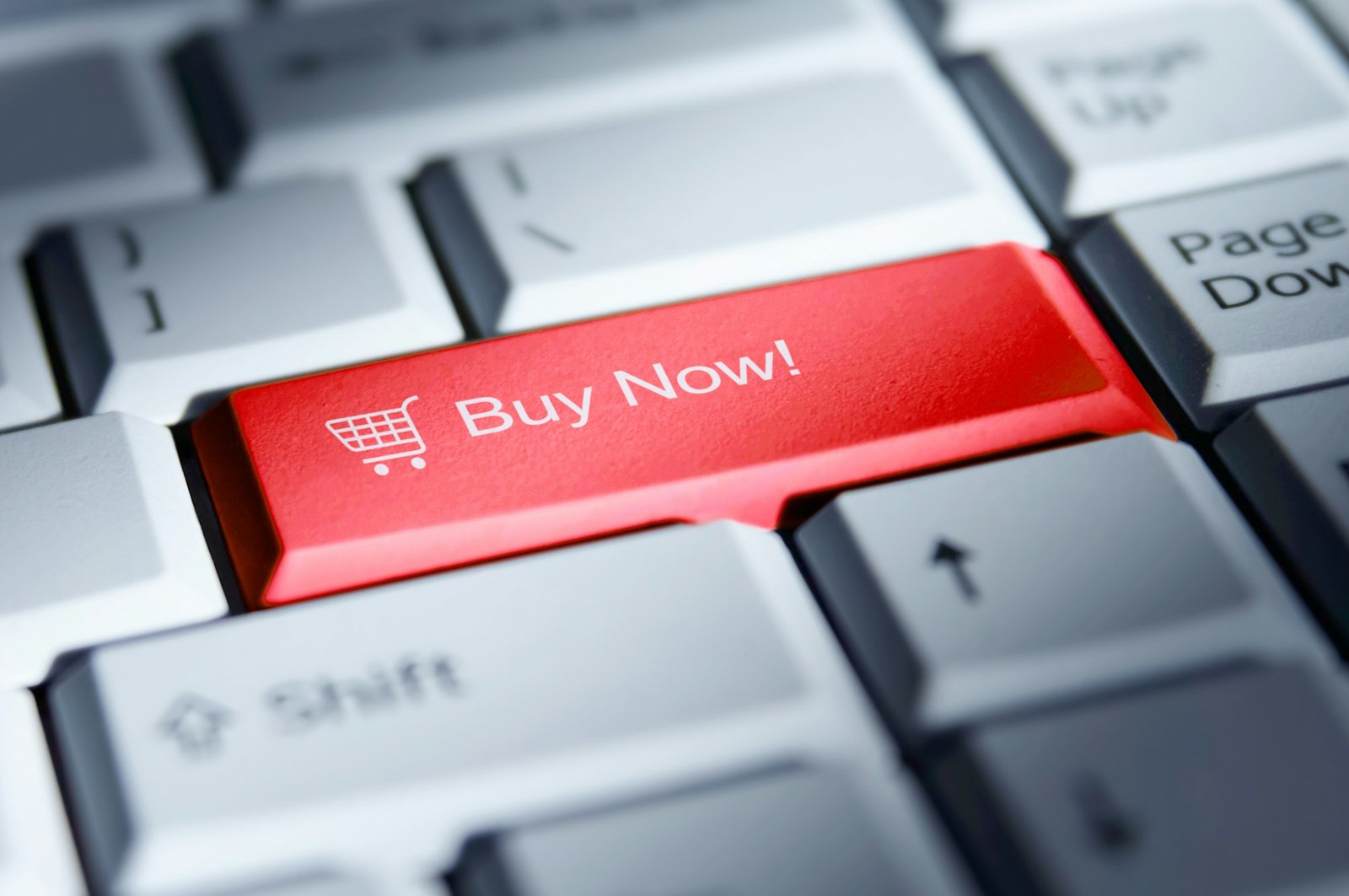 Red "buy now" button on a computer keyboard