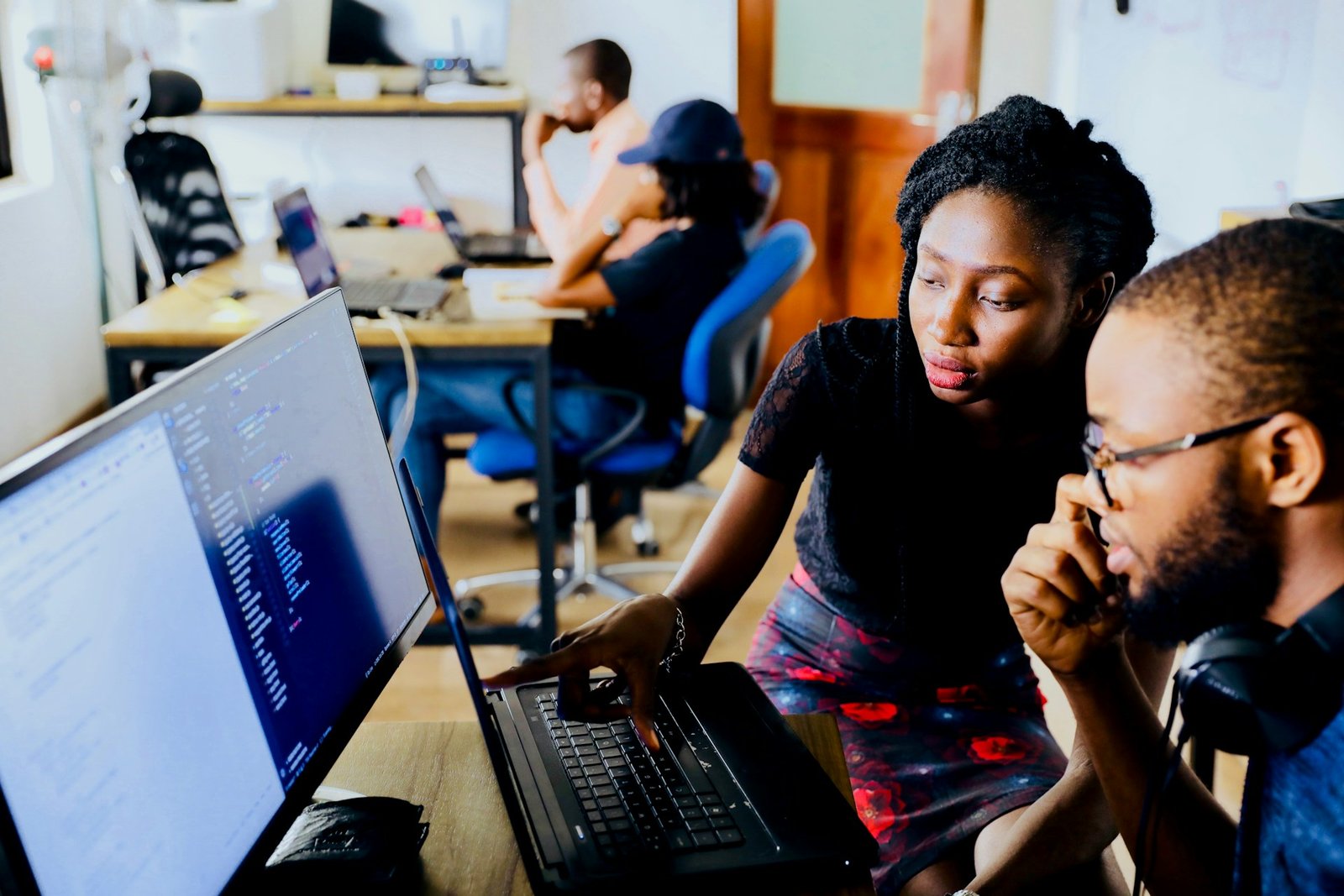 Two coworkers learning new software together, one of the hidden costs of switching accounting software
