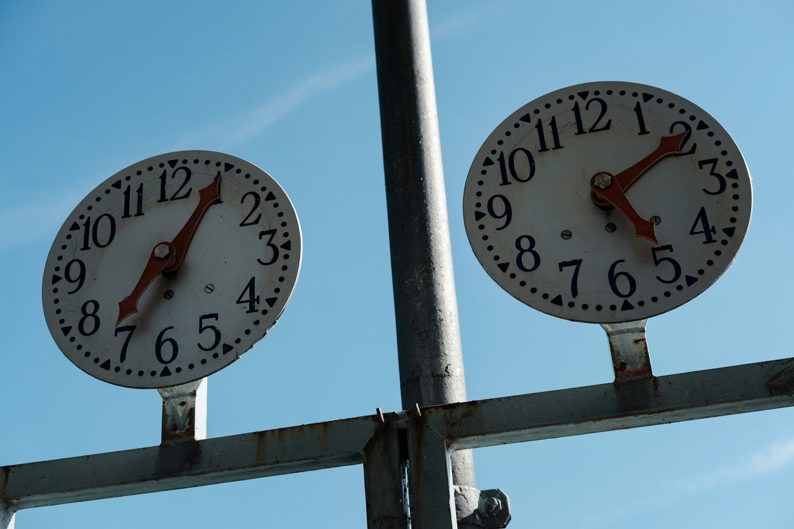 Two clocks showing different times, representing running two software subscriptions during an overlap period