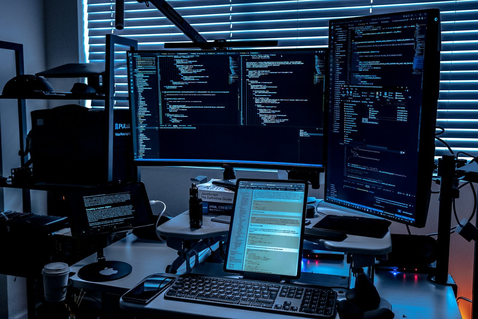 Desk with multiple monitors showing different connected apps and data