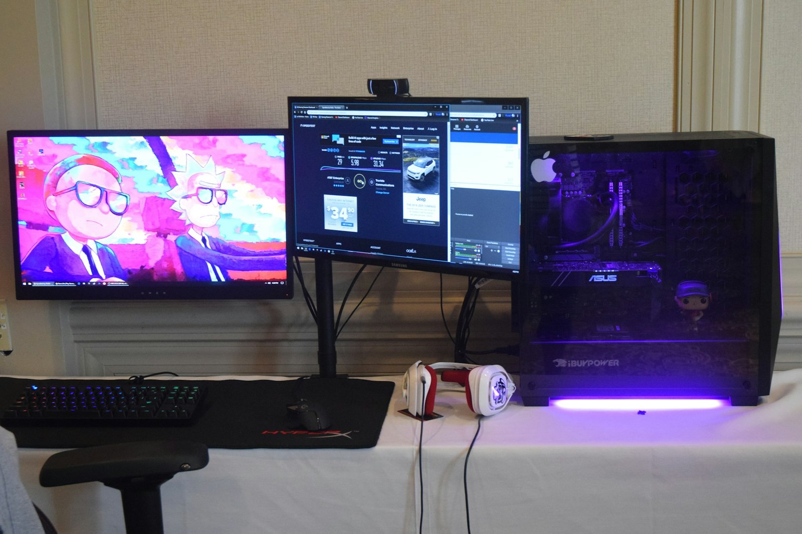 Black computer tower with two flat screen monitors, keyboard, and headphones, representing comparing two systems during a migrate from QuickBooks Desktop to Online project