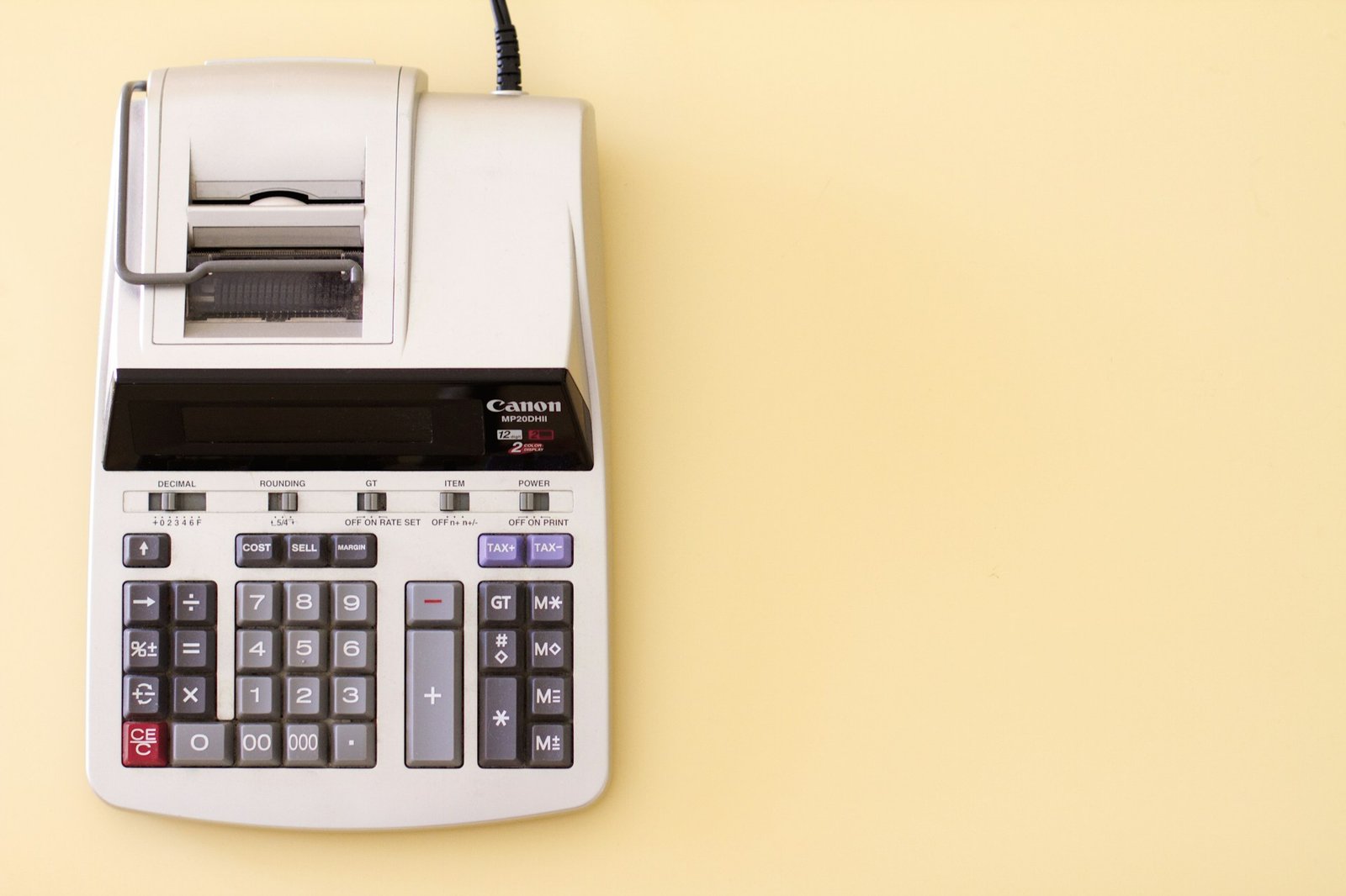 A printing calculator on a yellow background