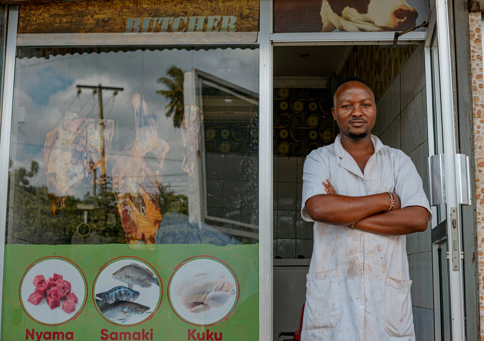 Small business owner standing outside his shop, ready to record a loan in QuickBooks