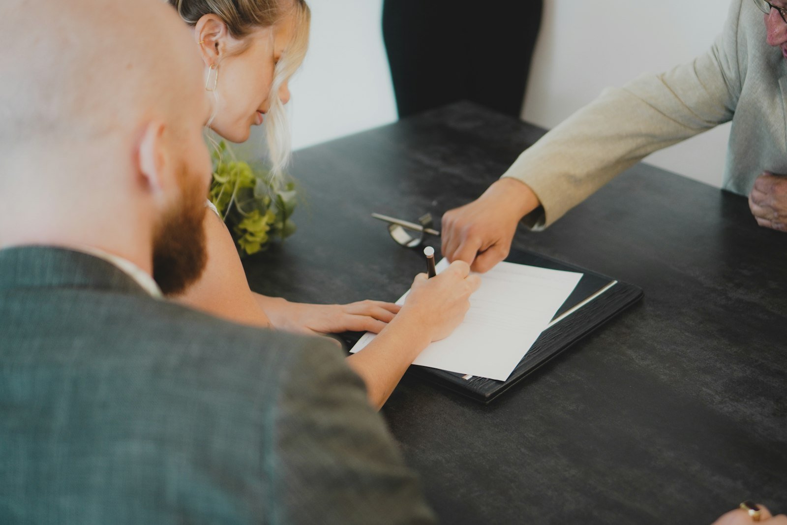 Couple signing a loan document at a desk