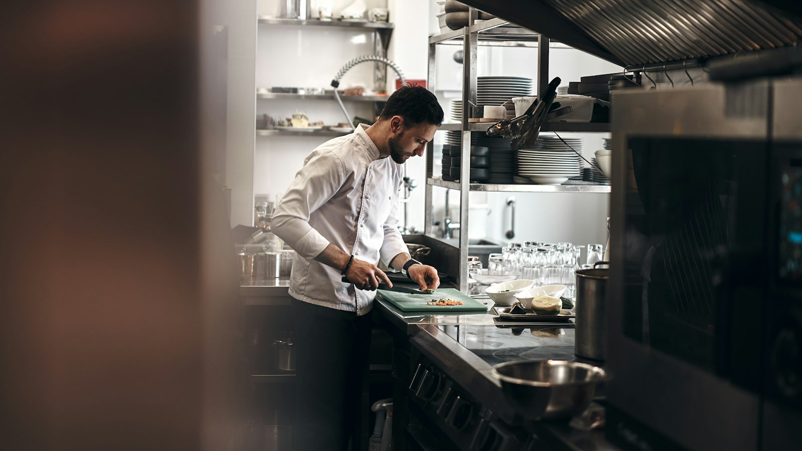 Chef chopping vegetables in a restaurant kitchen