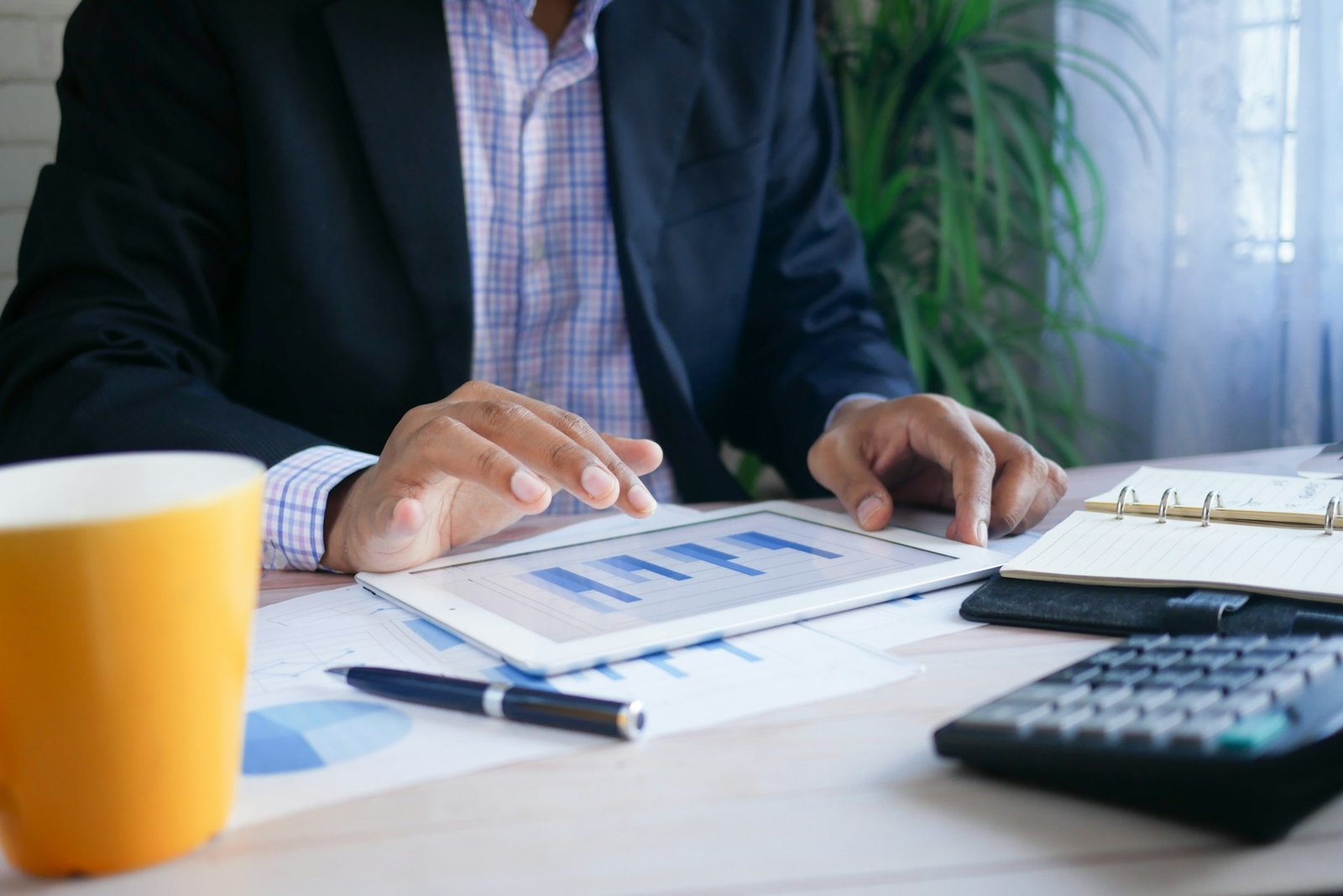 Person analyzing business charts on a laptop, part of how to run a P&L report in QuickBooks