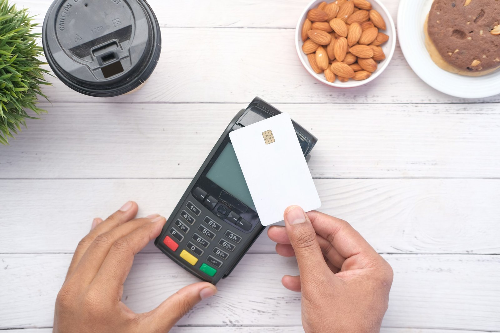 Credit card next to a calculator, comparing Stripe vs PayPal fees