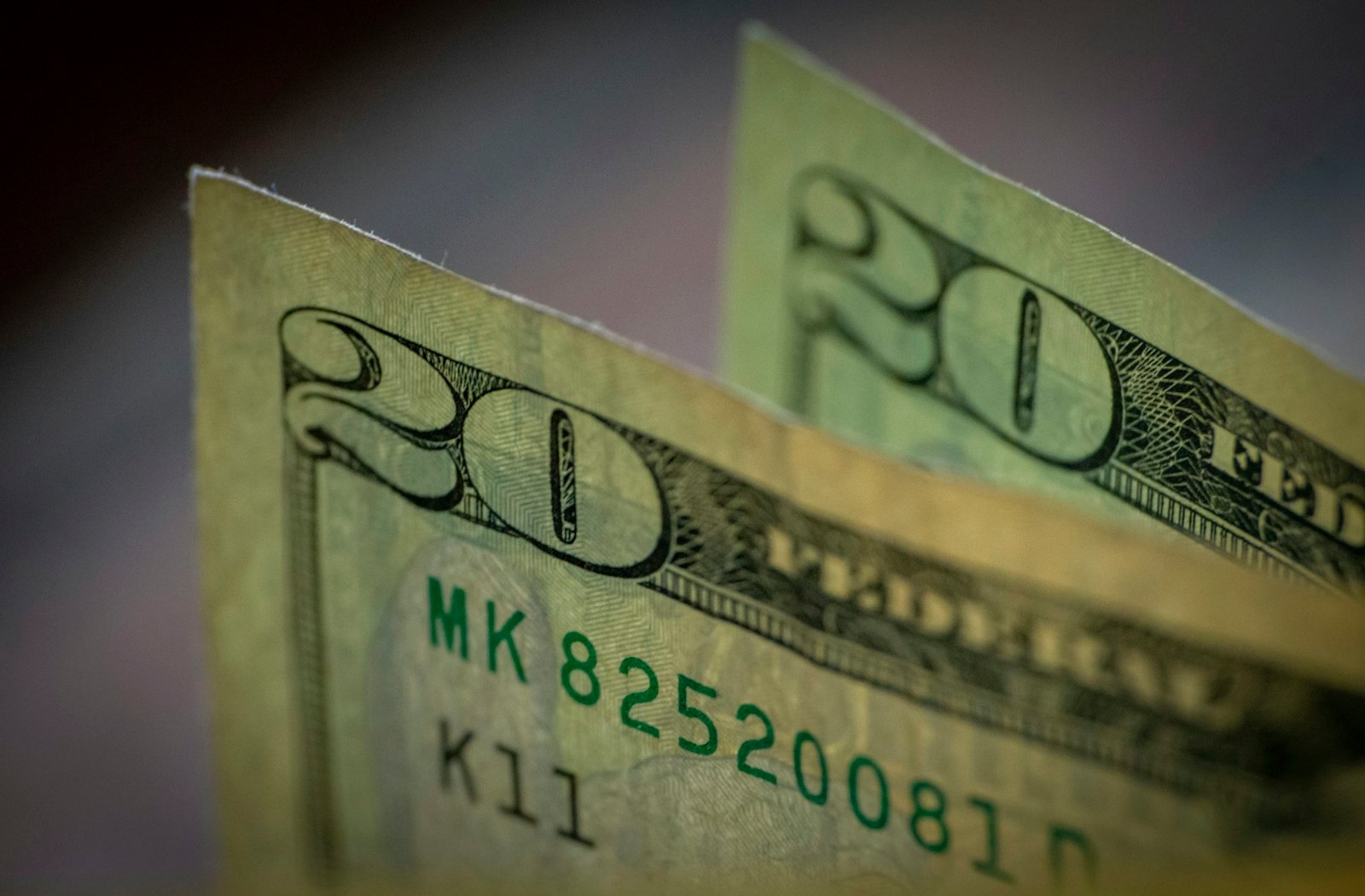 Two stacks of twenty dollar bills, one on top of the other, representing how to handle undeposited funds in QuickBooks