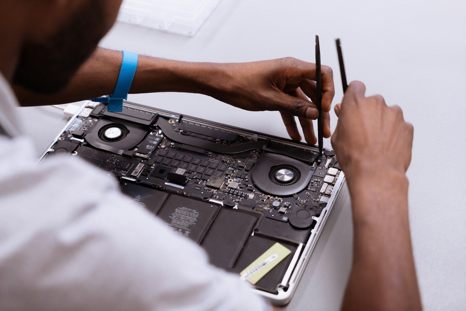 Person working on repairing a laptop, similar to repairing a QuickBooks installation