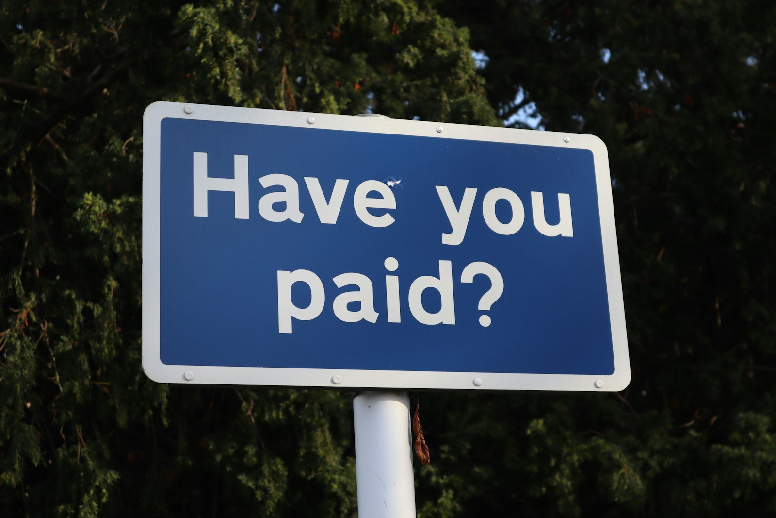 Blue sign asking whether you have paid