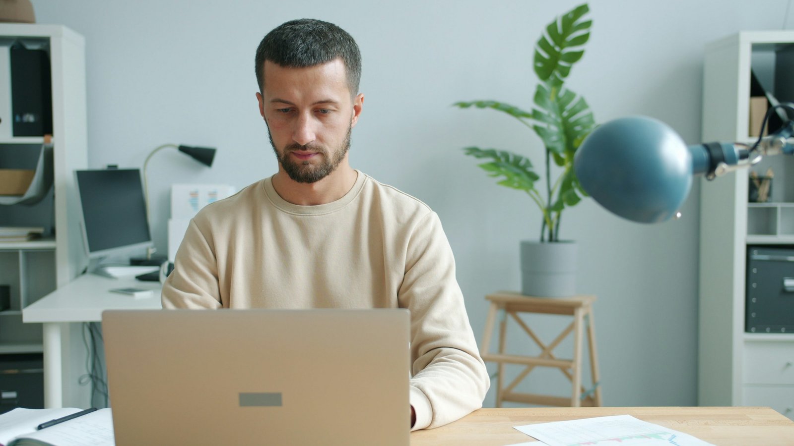 Small business owner comparing software pricing at a desk