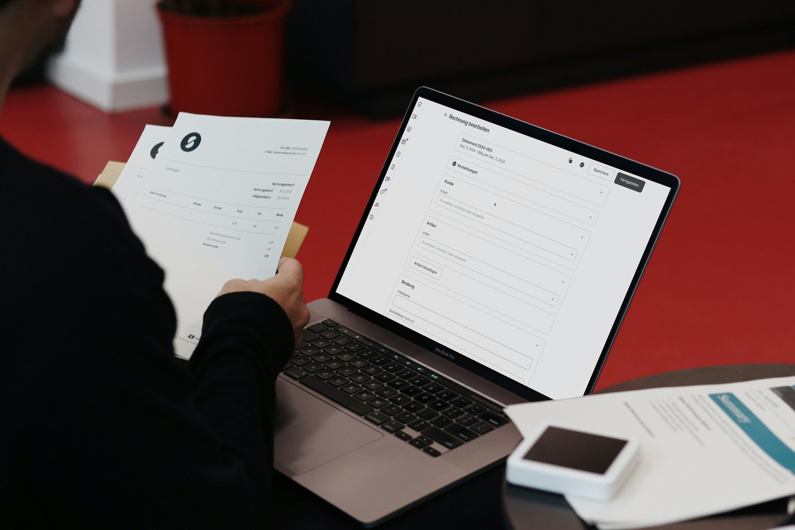 Person managing invoices at a laptop, comparing Xero vs QuickBooks pricing for invoicing limits
