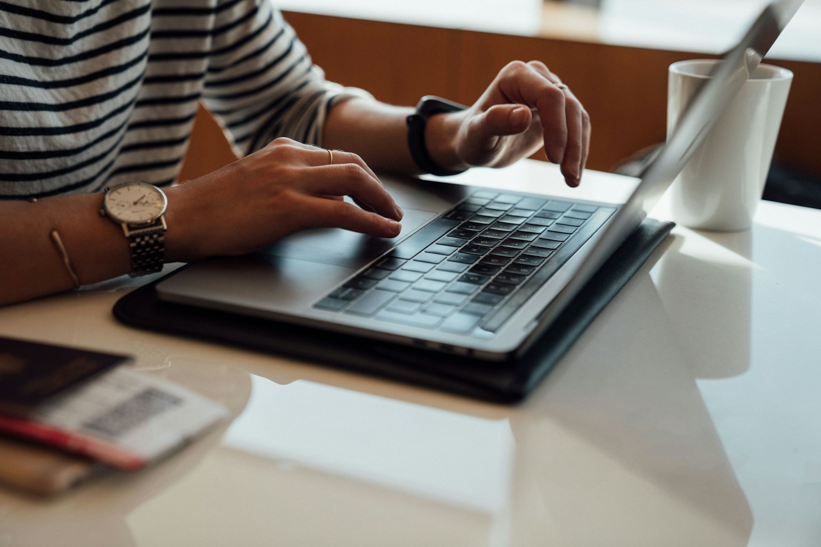 Person sitting at a table using a laptop